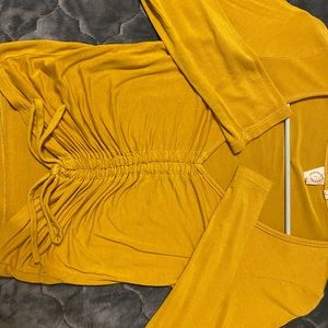 Super cute yellow top with pull strings to scrunch.